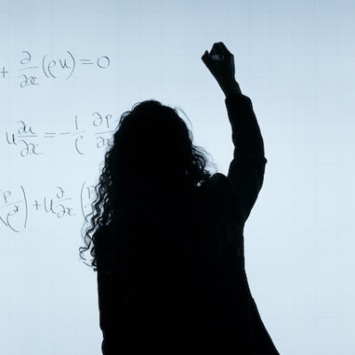 Image of woman writing on a whiteboard